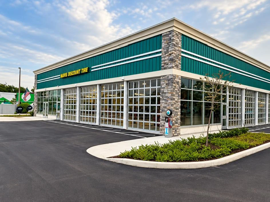 Mavis Tires — finished green facade with glass garage bays
